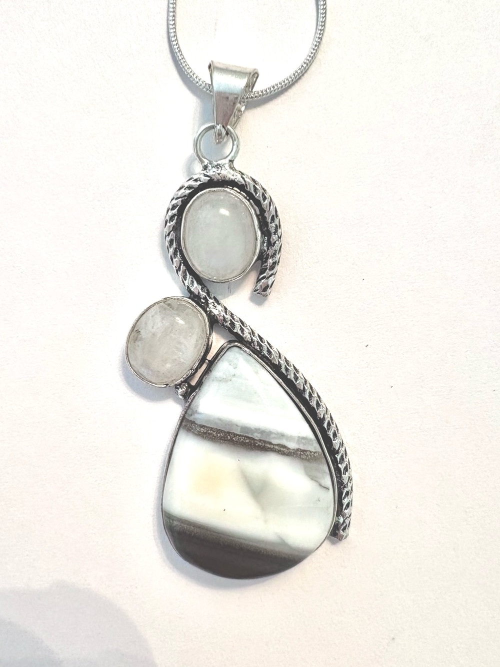 2 inch, Long Owhyee Blue Opal and Rainbow Moonstone . Pendant on a silver chain.